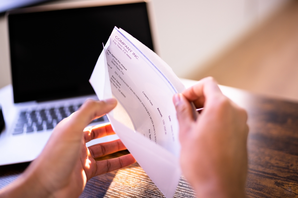 Payroll,Cheque,In,Envelope.,Man,Hand,Holding,Paycheck